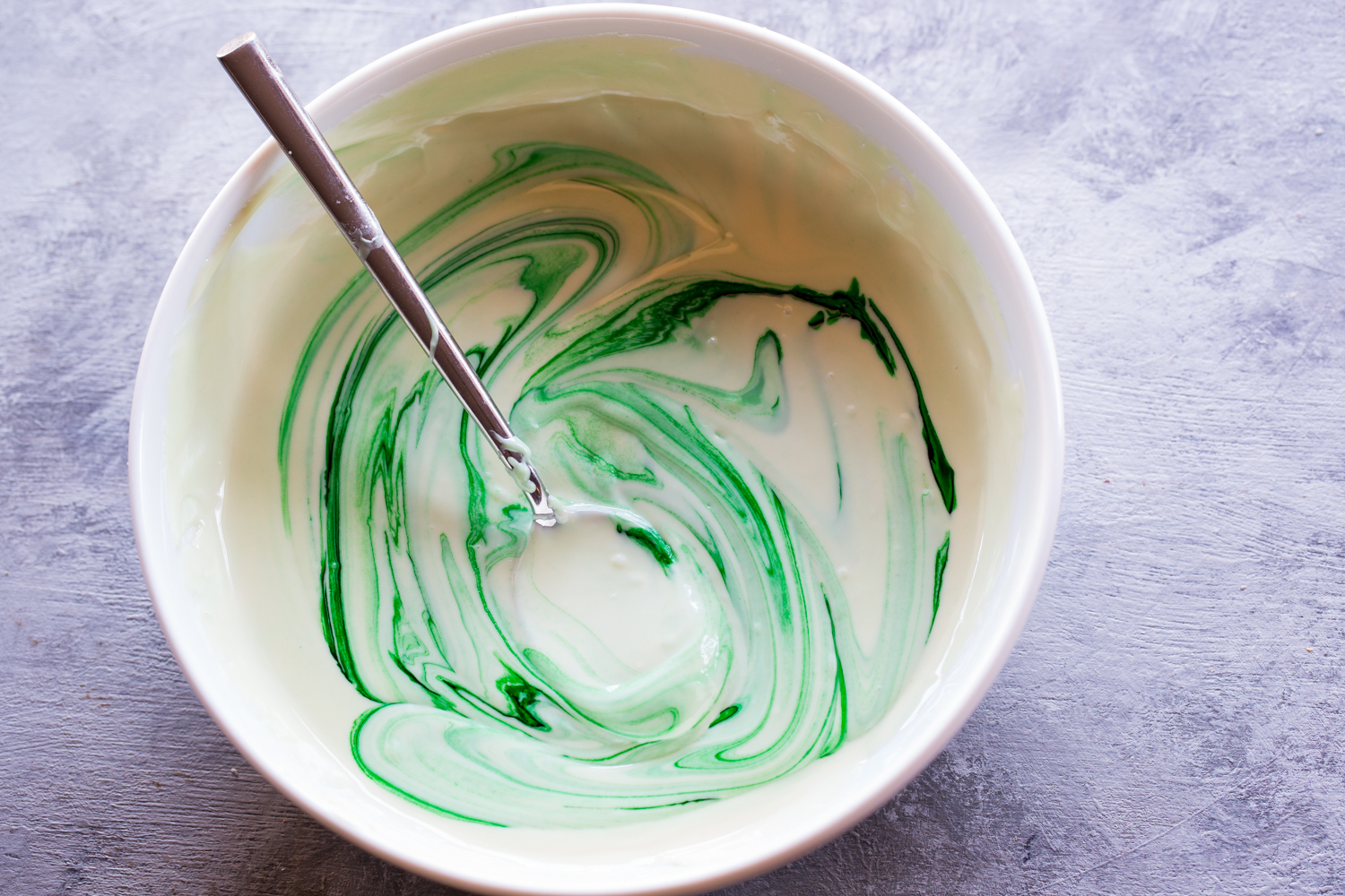 Christmas Tree OREO Cookie Balls are covered with melted white chocolate tinted a soft green. 