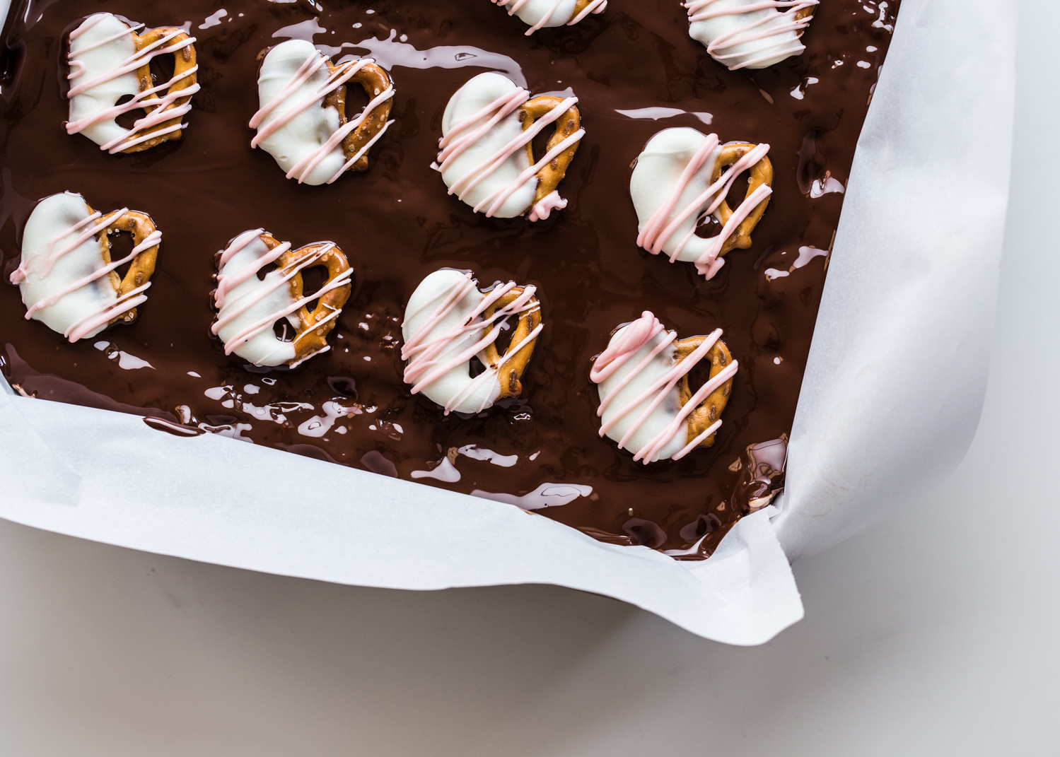 Chocolate Pretzel Cereal Treats topped with festive chocolate covered pretzels for Valentine's Day