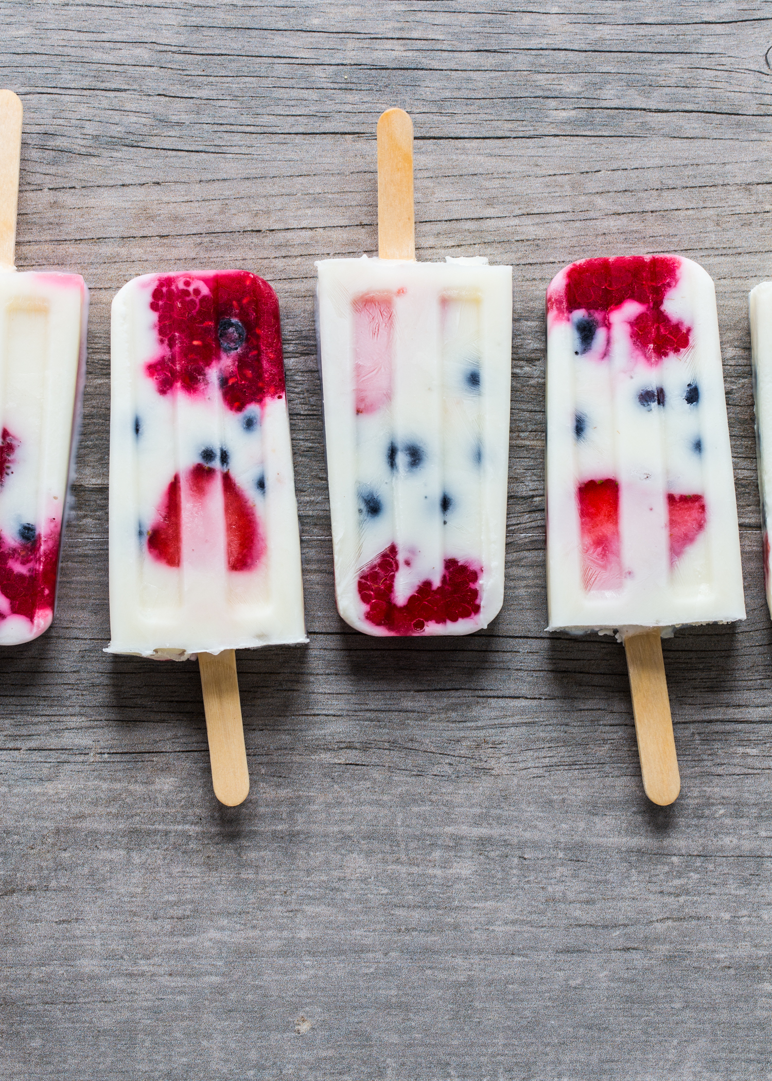 Creamy Vanilla Berry Popsicles made with milk, yogurt and fresh berries