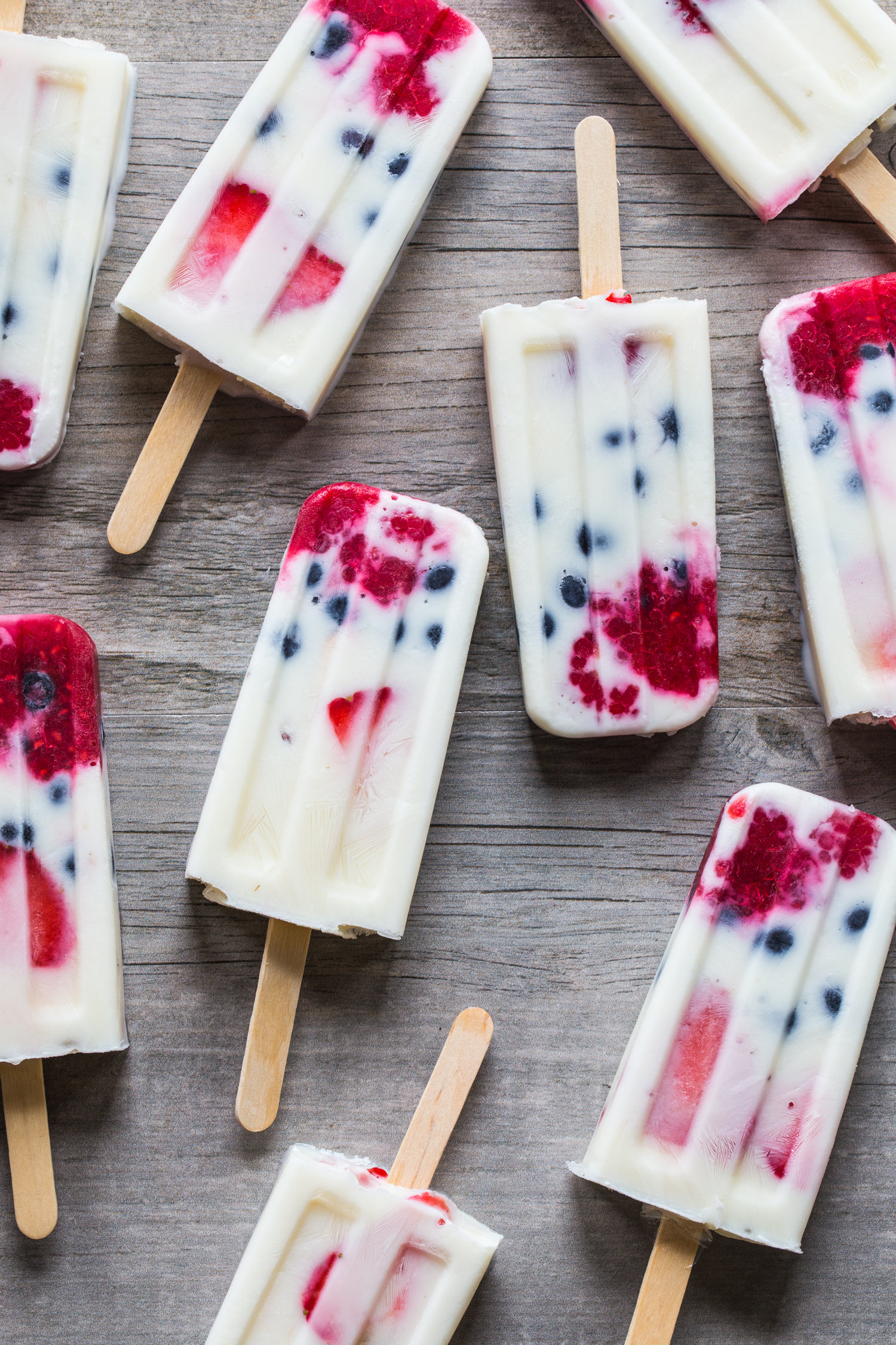 Creamy Vanilla Berry Popsicles made with wholesome milk, fresh berries, and vanilla yogurt