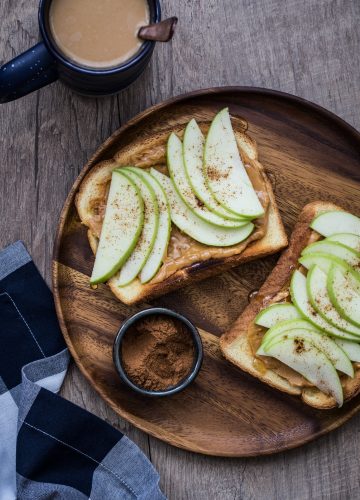 Apple Nut Butter Toast made with whole grain toast, nut butter, sliced apples, a drizzle of honey, and a pinch of cinnamon