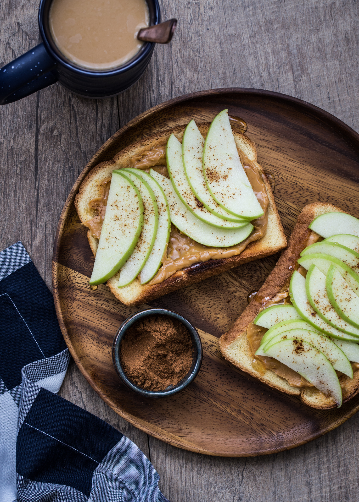 Apple Nut Butter Toast made with whole grain toast, nut butter, sliced apples, a drizzle of honey, and a pinch of cinnamon