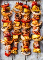 Sweet and Tangy Pork Kabobs with juicy pork, sweet red peppers, tangy pineapple, and spicy onions