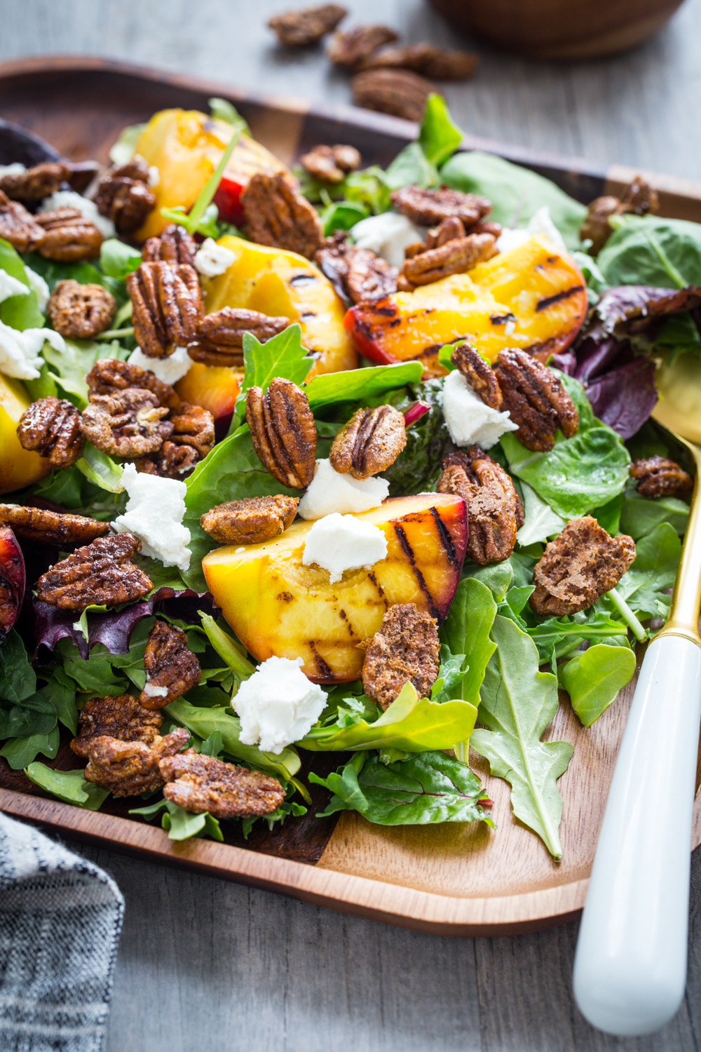 Spiced Pecan Grilled Peach Salad is a lovely summer salad topped with goat cheese and a simple vinaigrette