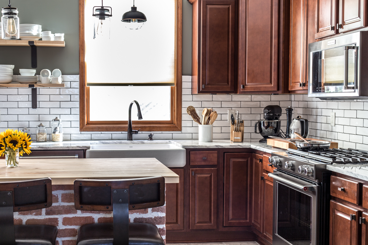 kitchen with white subway tile, black stainless, exposed brick, open shelves, black stainless kitchen renovation