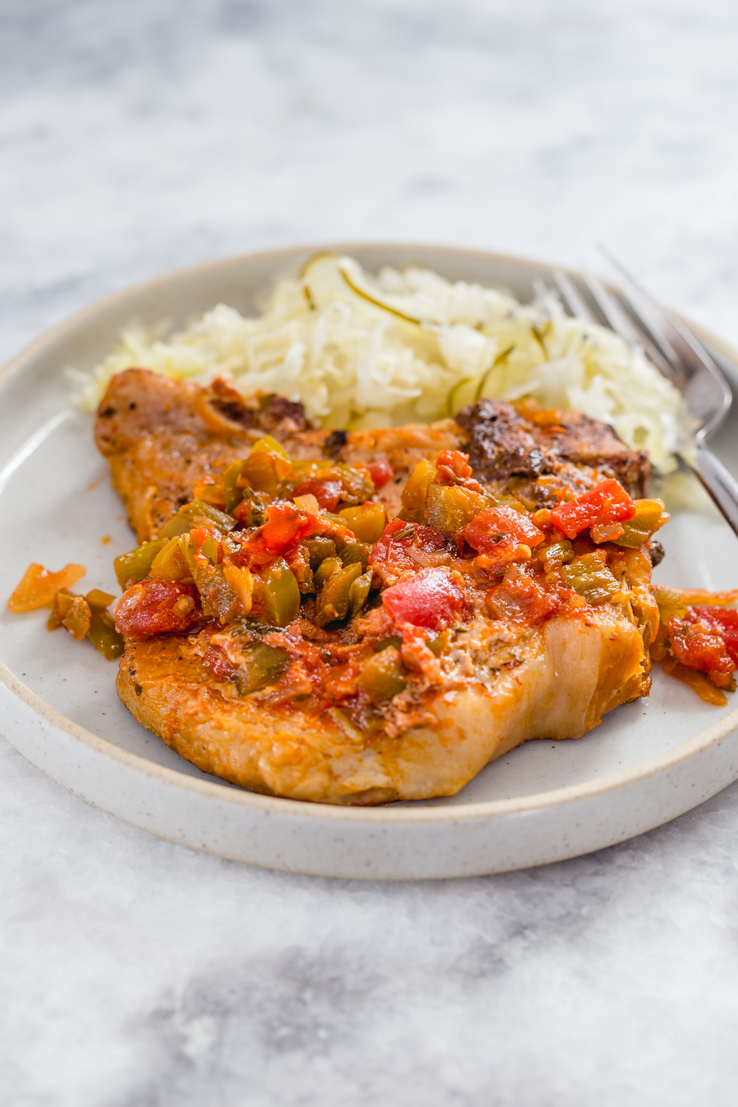 plate with pork chop and sauerkraut