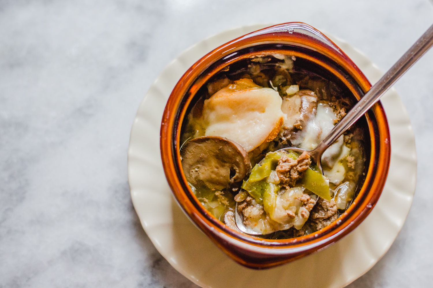 bowl of steak soup in brown bowl