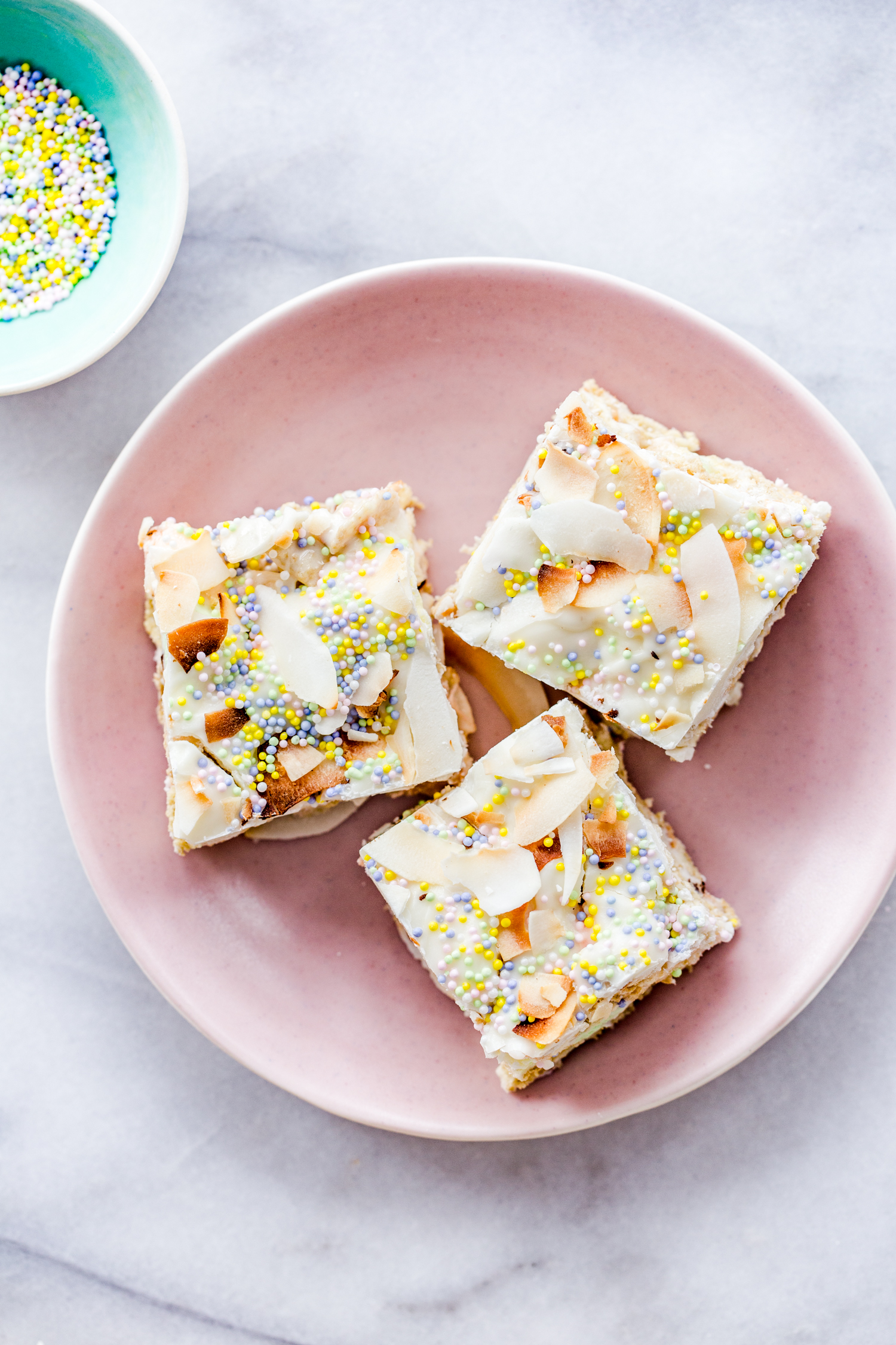 cereal treats on a pink plate with sprinkles